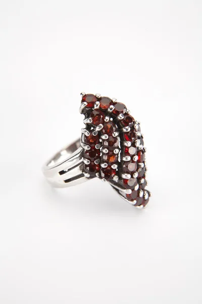 Silver ring with garnet stone on white. — Stock Photo, Image