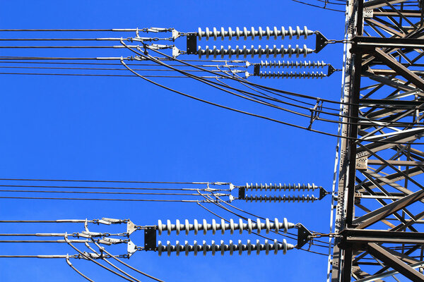 Electric high voltage pillar. Closeup of insulators. Sky background