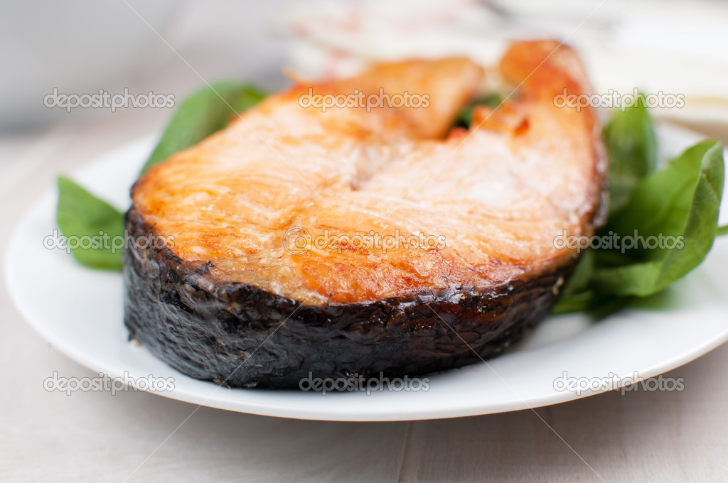 Grilled salmon steak on spinach