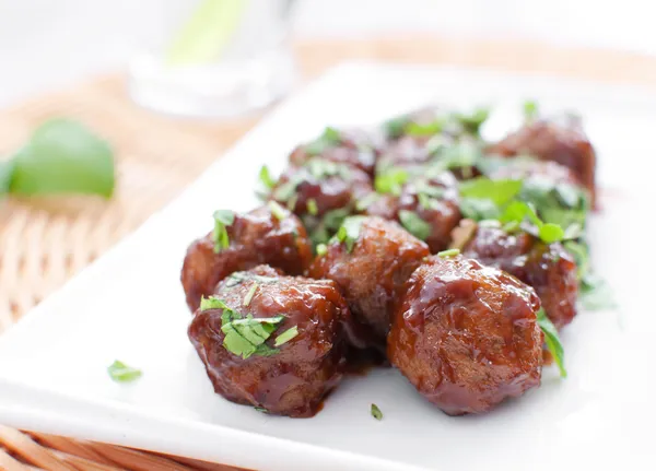 Plate of meatballs in gravy with herbs — Stock Photo, Image