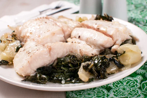 Fish fillet pieces on a green cabbage — Stock Photo, Image