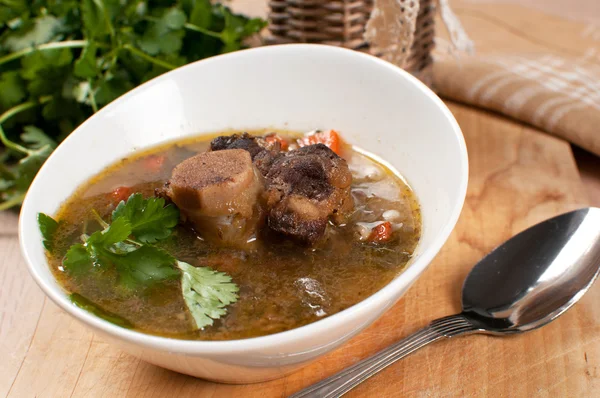 Hearty soup with bone-in ox tail — Stock Image Hearty soup with bone-in ox tail Stock Photo