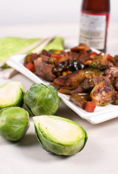 Grilled brussels sprouts with meat and sauce — Stock Photo, Image