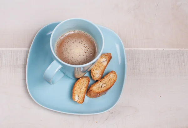 Almond small biscotti and blue cup — Stock Photo, Image