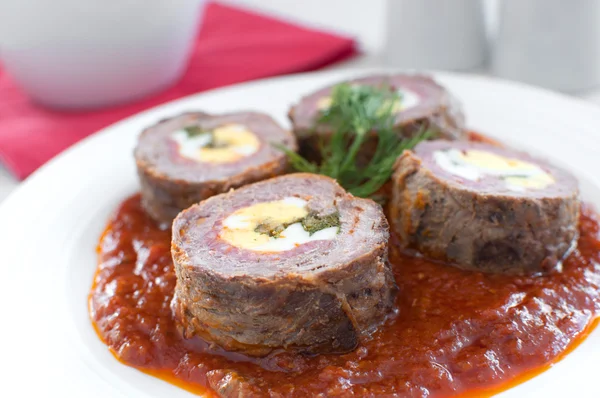 Roulade with meat and eggs in tomato sauce — Stock Photo, Image