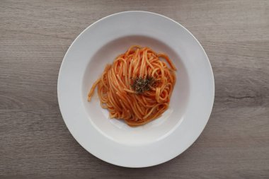 Delicious Italian Spaghetti with tomato sauce on wooden background. View from above. Italy