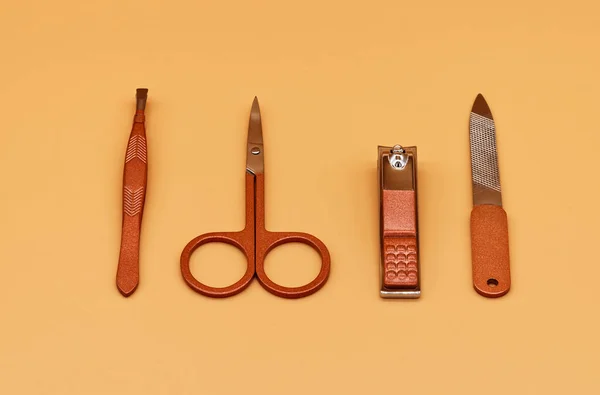 Set for cutting nails. Tools of a manicure set on a beige background