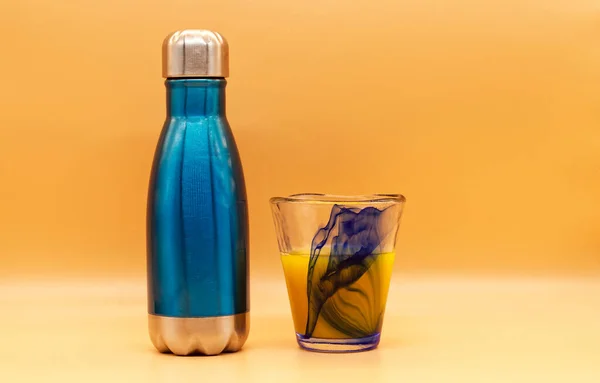 Blue Silver Bottle Glass Isolated Orange Background — Foto Stock