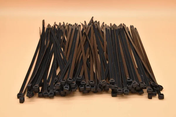 Black Cable Ties Isolated Orange Background Plastic Tie Wraps — 图库照片