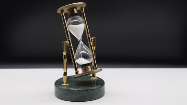 Hourglass White Table Isolated Black Background Time Passing Concept — ストック動画