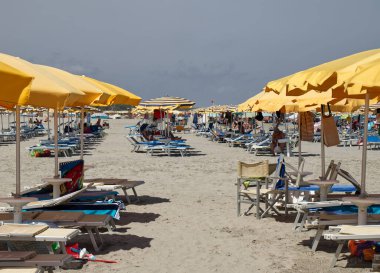 Punta Marina Terme, Ravenna - Italy - August 17, 2022: : Italian beach view with umbrellas and sunbeds. Summer day on the beach. Riviera Romagnola, Italy