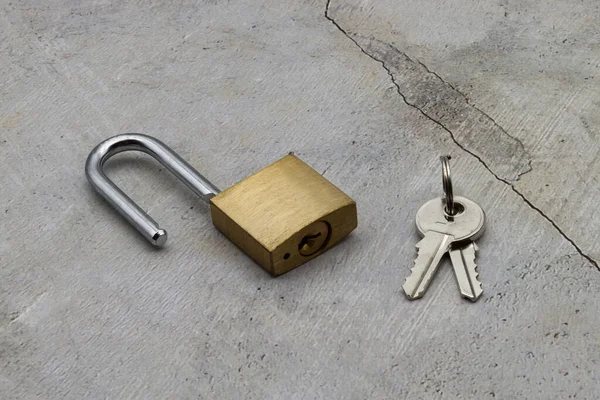 Unlocked padlock with the keys isolated on clear background