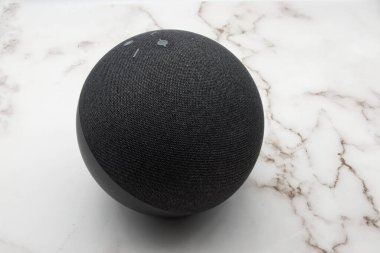 Bologna - Italy - September 1, 2022: Amazon Echo. Alexa, virtual assistant AI. Marble background