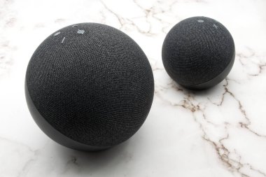 Bologna - Italy - September 1, 2022: Amazon Echo and Echo Dot. Alexa, virtual assistant AI. Marble background