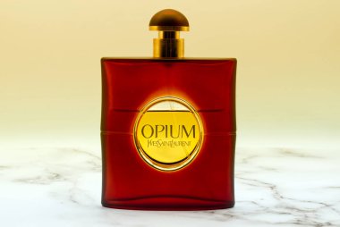 Bologna - Italy - September 1, 2022: Opium Perfume by Yves Saint Laurent isolated on yellow background