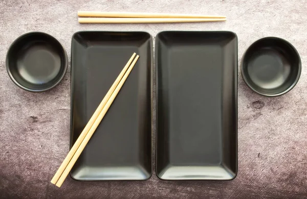 Black Slate Plate with Chopstick grey concrete background. Flat Lay. Asian Food Concept