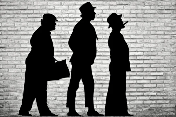 Light and shadow - The shadows of three men on the wall. — Stock Photo, Image