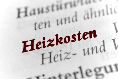 Heating costs - German black white text with brown red letters 