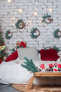 Bedroom is decorated for New Year. Interior details with Christmas decor..