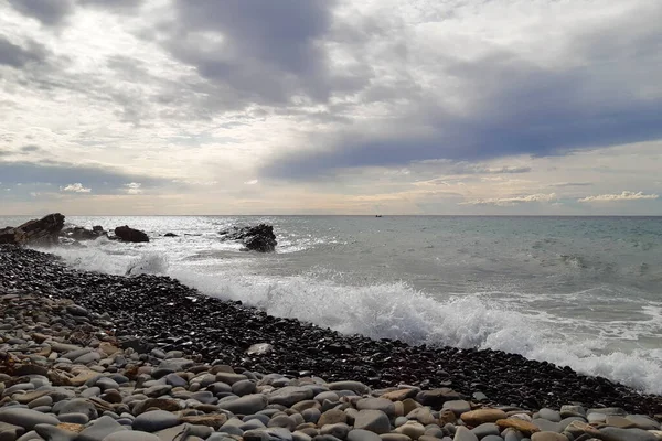 Bir çakıl taşı plajında dalgalar ve Liguria 'daki Diano Marina' da deniz manzarası, İtalya 'daki seyahat ve manzaralar.