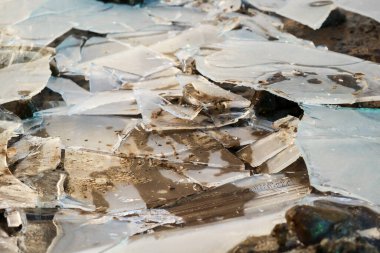 Close up of a cracked ice sheet in the garden, nature in winter