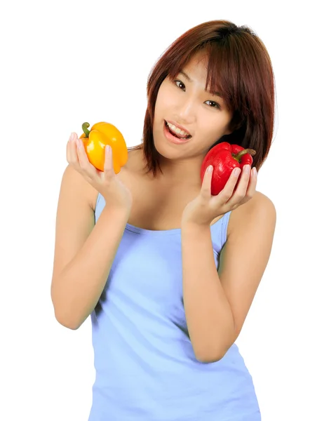 Isolated young asian woman with paprika on white — Stock Photo, Image