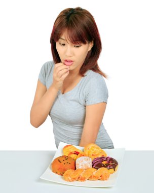 Masanın üzerinde bir donut ile izole genç Asyalı kadın