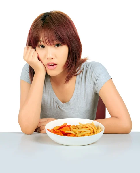 Isolated young asian woman with a plate of potato chips and fren — Stock Photo, Image