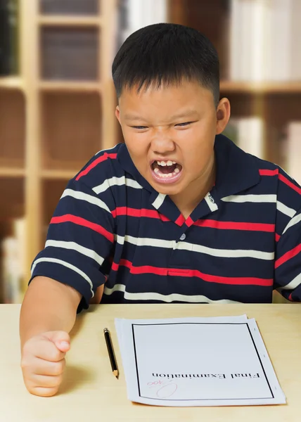 Young asian boy upset with his exam result — Stock Photo, Image