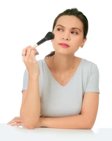 Isolated middle age asian woman with make up brush. — Stock Photo, Image