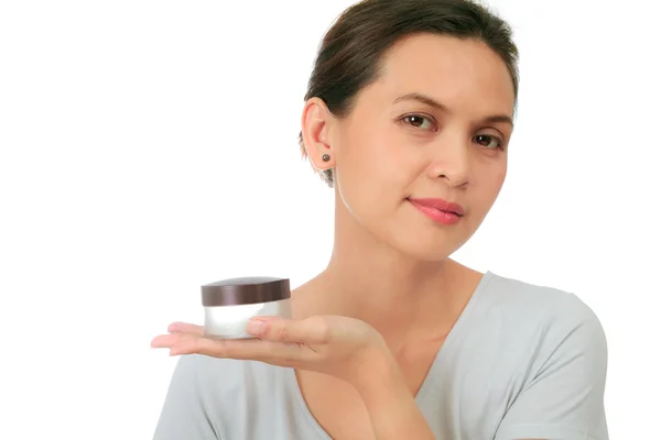Isolated middle age asian woman with cosmetic cream — Stock Photo, Image