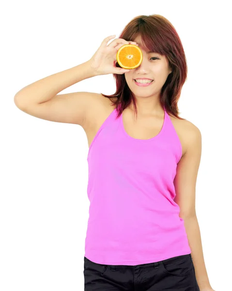 Isolated young asian woman with chopped orange — Stock Photo, Image