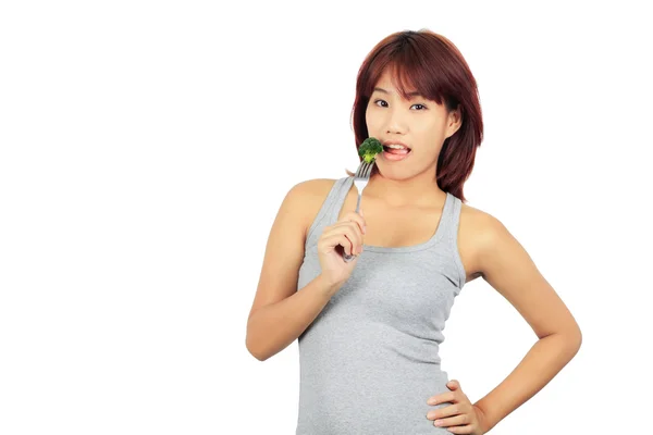 Isolierte junge asiatische Frau mit einem picec von brocolli — Stockfoto