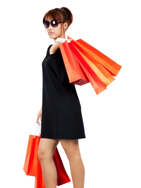 Isolated young asian woman carries shopping bags — Stock Photo, Image