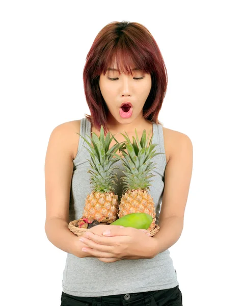 Isolated young asian woman with variety of oriental fruits. — Stock Photo, Image