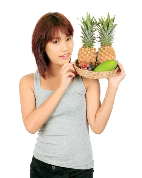 Geïsoleerde jonge Aziatische vrouw met verscheidenheid van oosterse vruchten. — Stockfoto