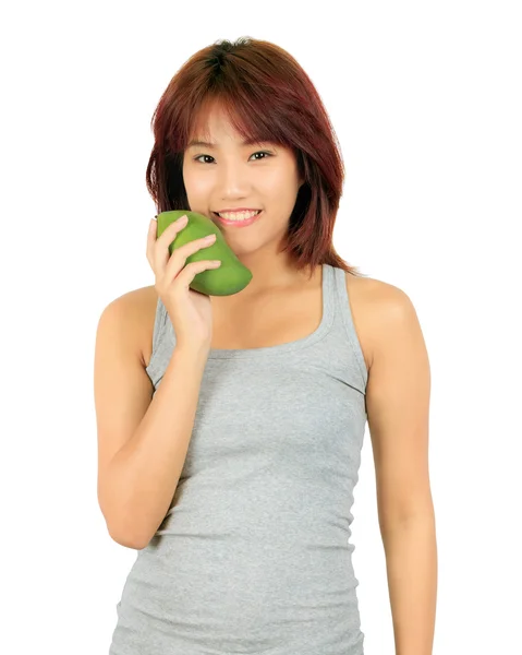 Isolierte junge asiatische Frau mit einer Mango über weiß. — Stockfoto