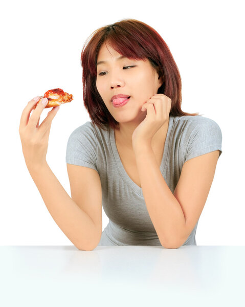 Isolated young asian woman with a piece of pizza
