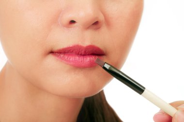 Isolated closedup on the lips of an asian middle age woman clipart