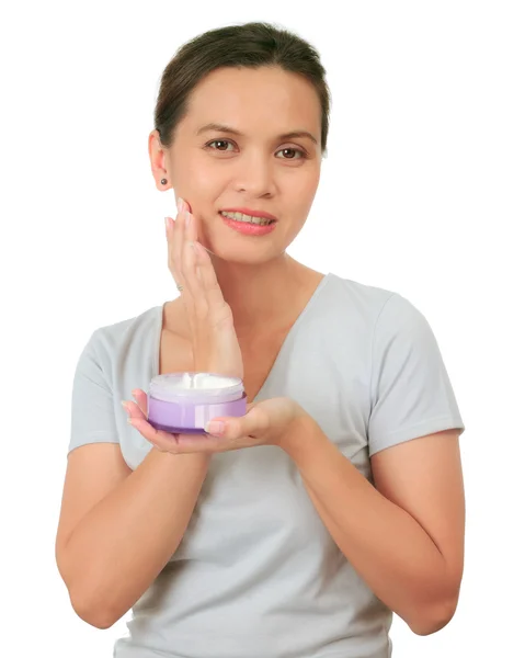 Isolated middle age asian woman with cosmetic cream — Stock Photo, Image