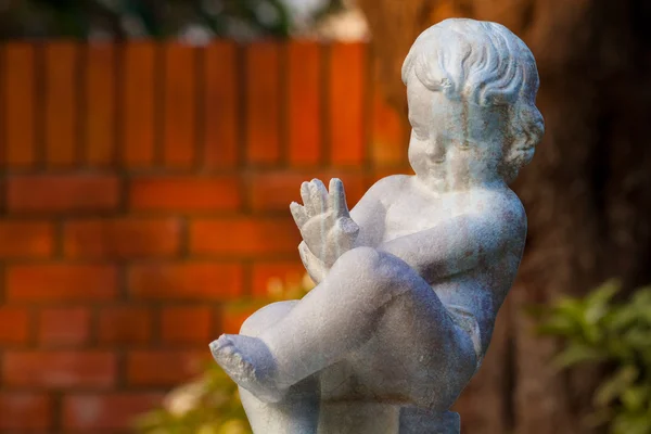 婴儿雕塑在花园中 — 图库照片