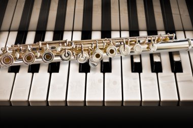 A concert flute with a piano clipart