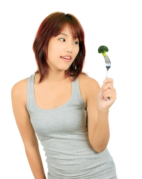 Mujer asiática joven aislada con un pedazo de brócoli —  Fotos de Stock