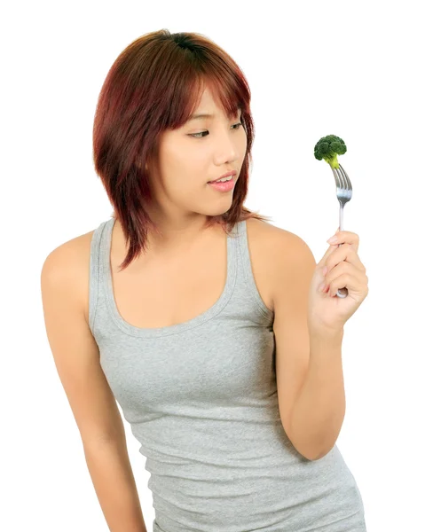 Isollated junge asiatische Frau mit einem Stück Brokkoli — Stockfoto