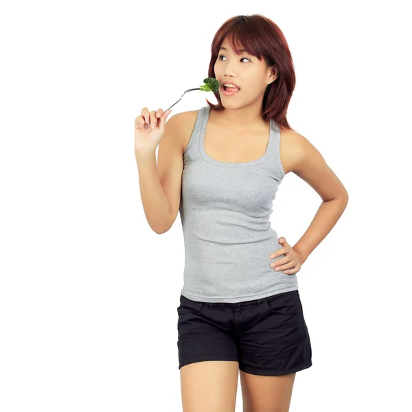 Isolated young asian woman with a picec of brocolli — Stock Photo, Image