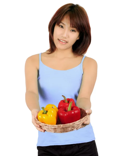 Isolated young asian woman with paprika on white — Stock Photo, Image