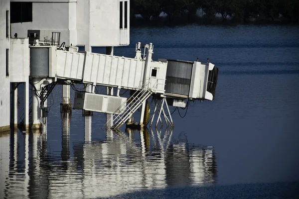 A terminal gate rises above the water
