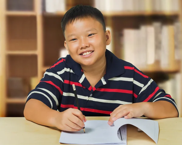 Młody chłopiec azjatyckich zadowolony z jego pracy domowej — Zdjęcie stockowe