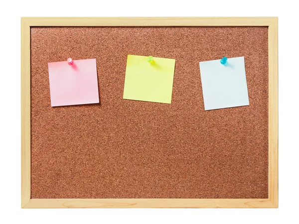 Cork board with plastic pins and blank notes Stock Photo