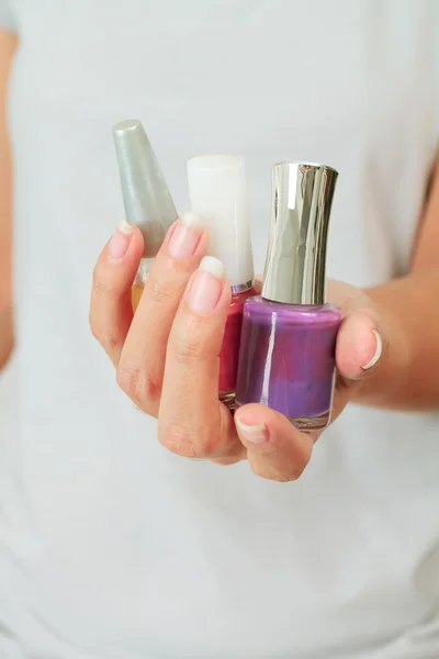 Female hand with nail varnish bottles — Stock Photo, Image
